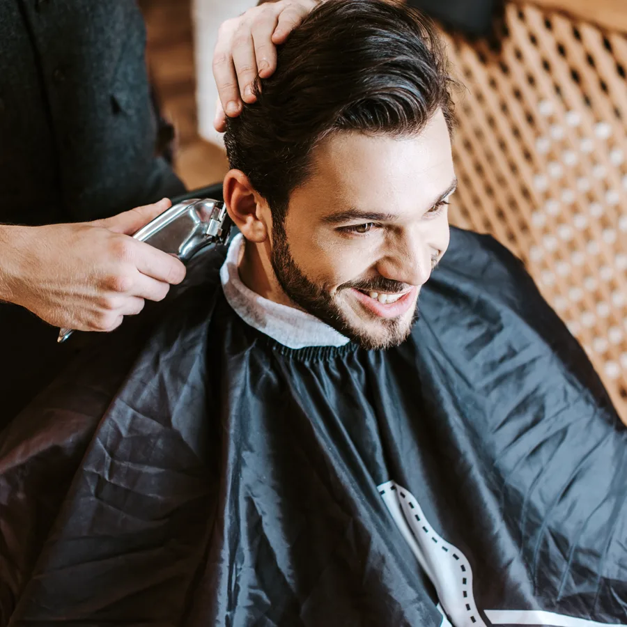 Ray cutting a client's hair at Northside Barbershop